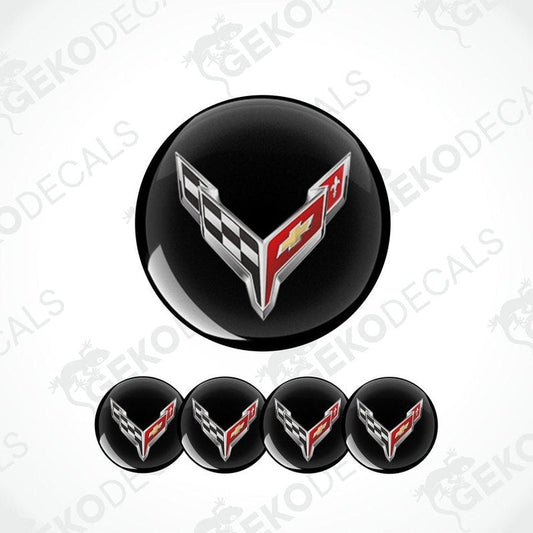 A set of four black vinyl stickers with a checkered pattern and the Chevrolet Corvette logo in the center.