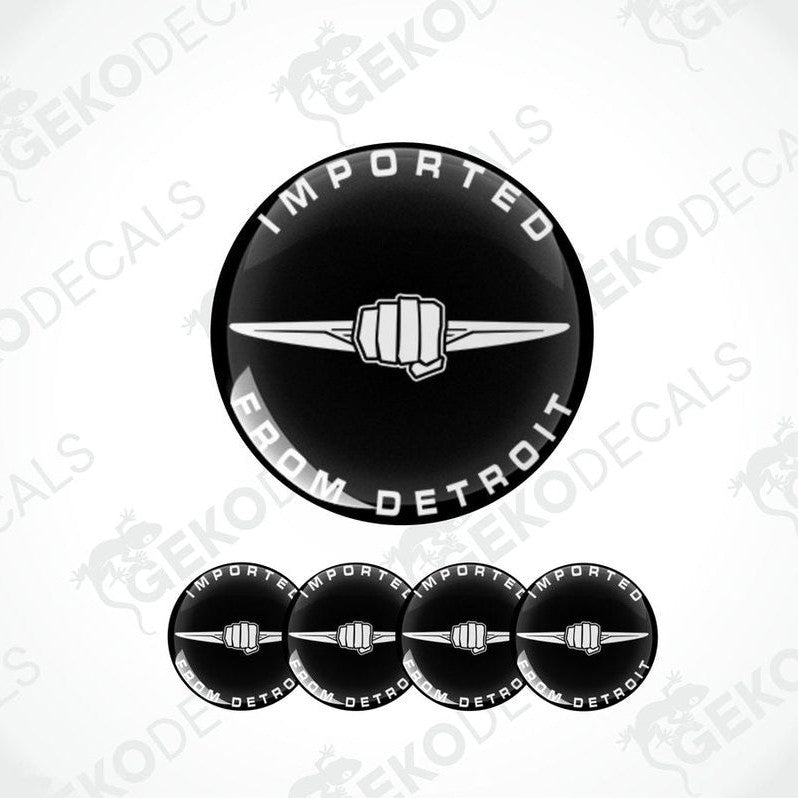 A set of black vinyl stickers with the text 'IMPORTED FROM DETROIT' and a fist graphic on them.
