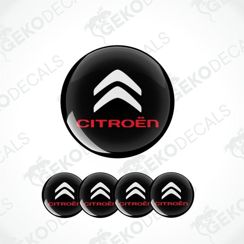 A set of black and white vinyl decals with the CITROEN logo, intended for use as car wheel caps and stickers.