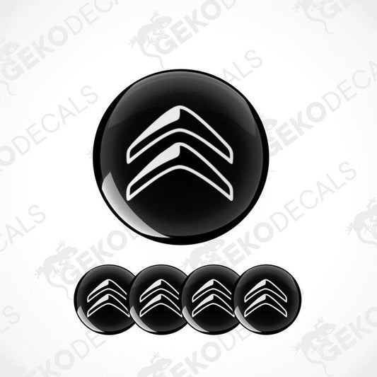 A set of four black vinyl stickers with a white chevron pattern, designed to be applied on car wheels or caps.