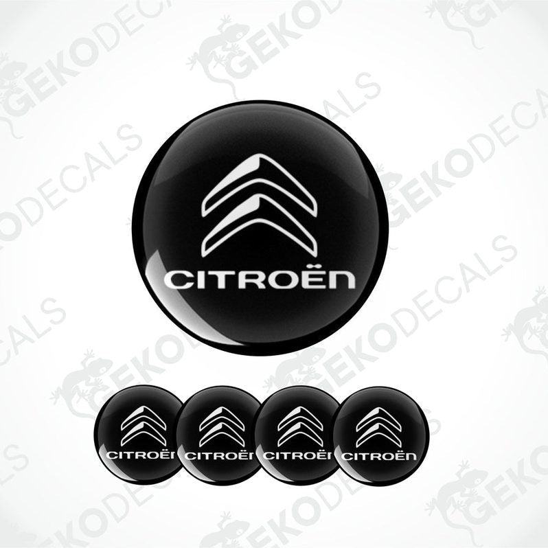 A set of four black vinyl stickers with the CITROEN brand logo on them.