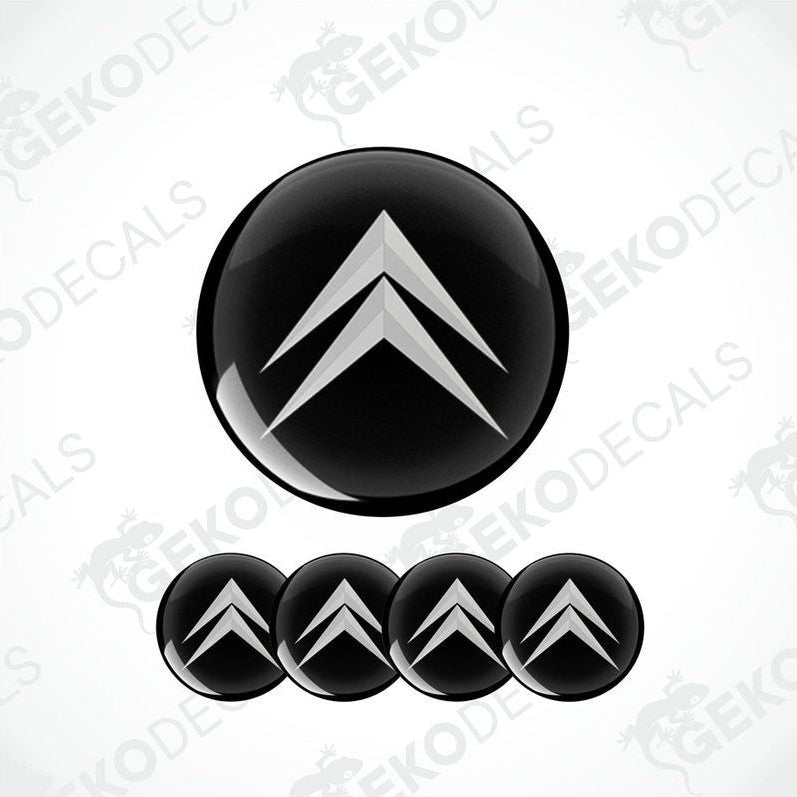 A set of four black vinyl stickers with a geometric pattern, designed for use as car decals or wheel caps.