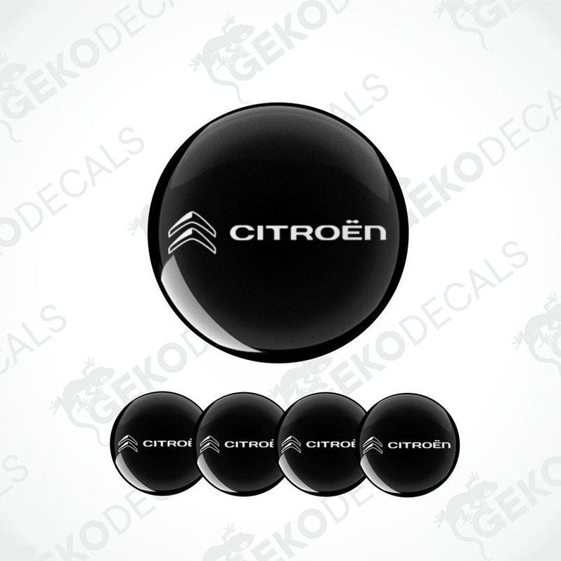 A set of four black vinyl stickers with the CITROEN brand logo on them.