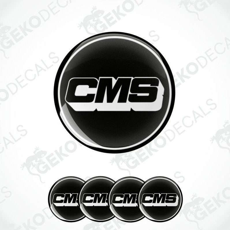 A set of four black round vinyl stickers with the CMS logo in white.