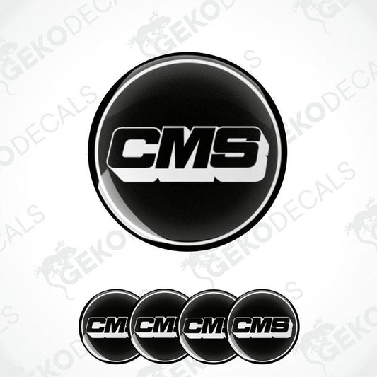 A set of four black round vinyl stickers with the CMS logo in white.
