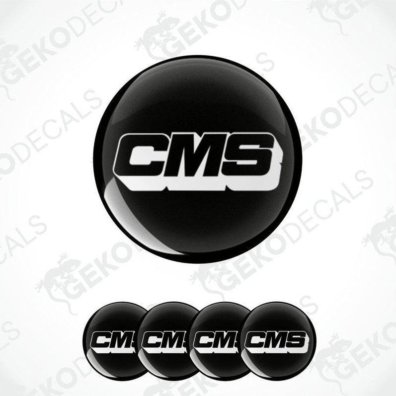 A set of four black round vinyl stickers with the CMS logo in white.