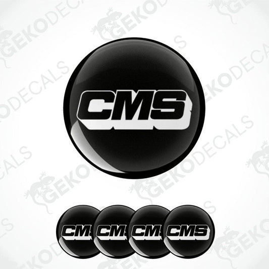 A set of four black round vinyl stickers with the CMS logo in white.