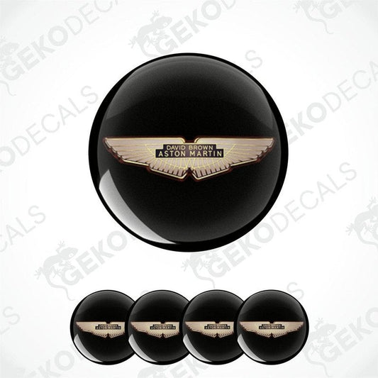 A set of four black vinyl stickers with the Aston Martin logo in the center.