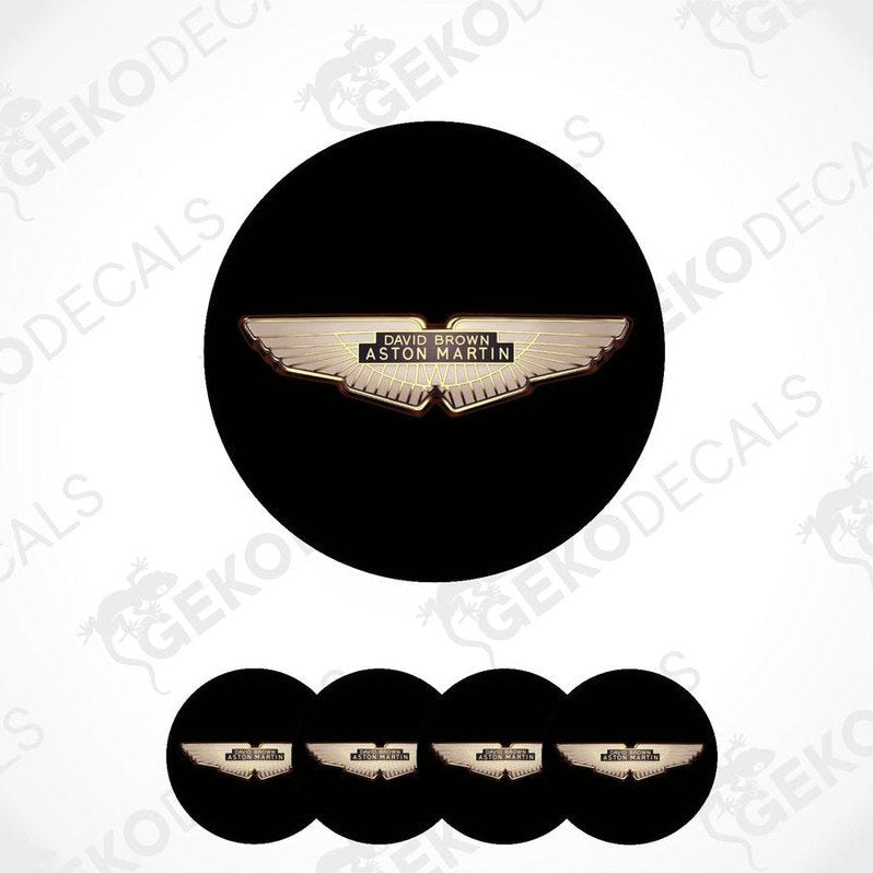 A set of four black vinyl stickers with the Aston Martin logo in the center.