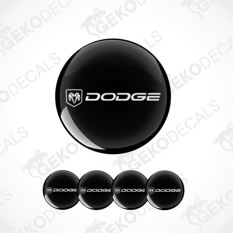 A set of black vinyl decals with the Dodge logo, including four round stickers and one larger oval sticker.
