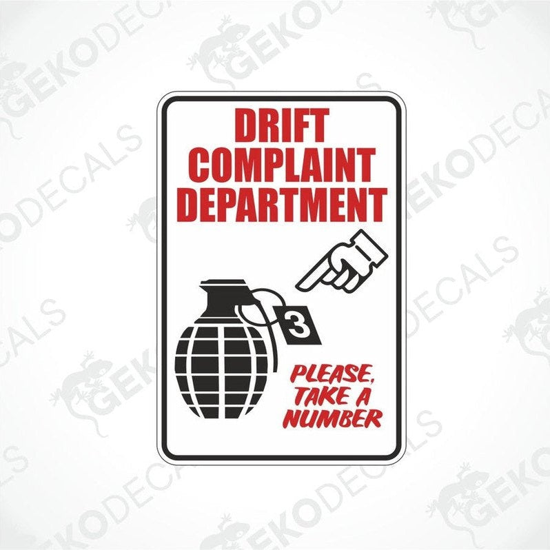 A black and red 'DRIFT COMPLAINT DEPARTMENT' sticker with a graphic of a bomb and a finger pointing upwards, indicating the placement of the sticker on a vehicle.