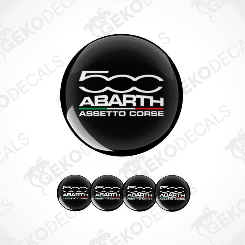 A set of four black vinyl stickers with 'ABARTH ASSESTO CORSE' text and a logo depicting a spiral design, displayed on a white background.