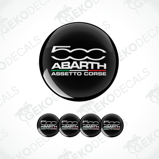 A set of four black vinyl stickers with 'ABARTH ASSESTO CORSE' text and a logo depicting a spiral design, displayed on a white background.