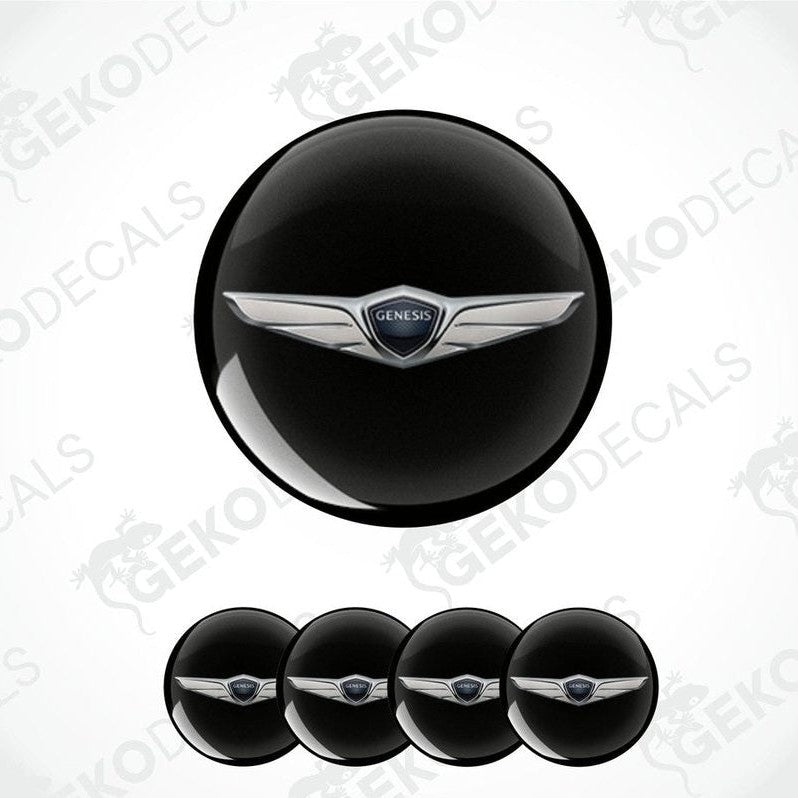 A set of four black vinyl stickers with a silver Genesis brand emblem in the center.