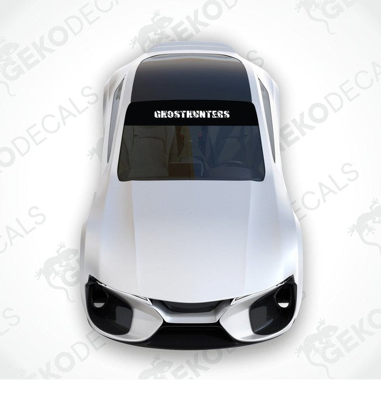 Black car windshield sun visor with white text CHOSTHUNTERS