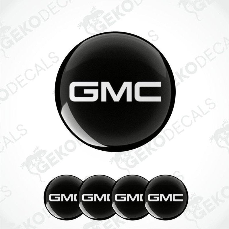 A set of four black round car decals with the GMC logo in white.