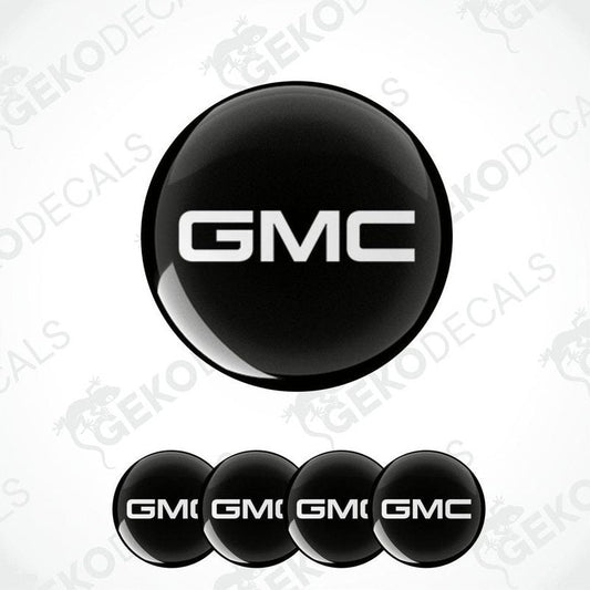A set of four black round car decals with the GMC logo in white.