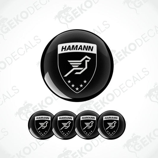 A set of four black vinyl stickers with the HAMANN brand logo featuring a bird and stars design.