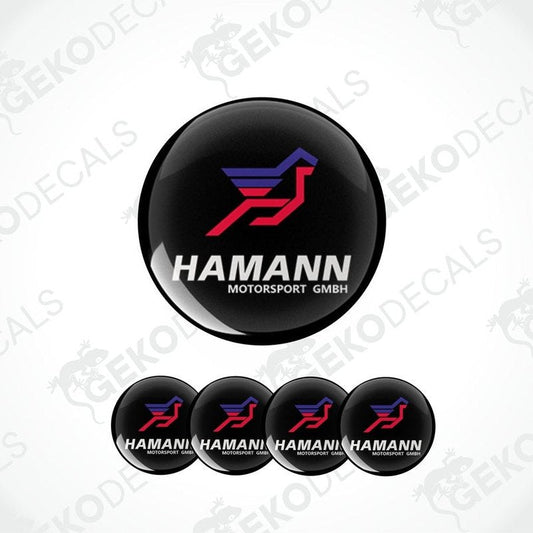 A set of four black vinyl stickers with red and blue geometric designs, featuring the brand name 'HAMANN' and the text 'Motorsport GMBH'.