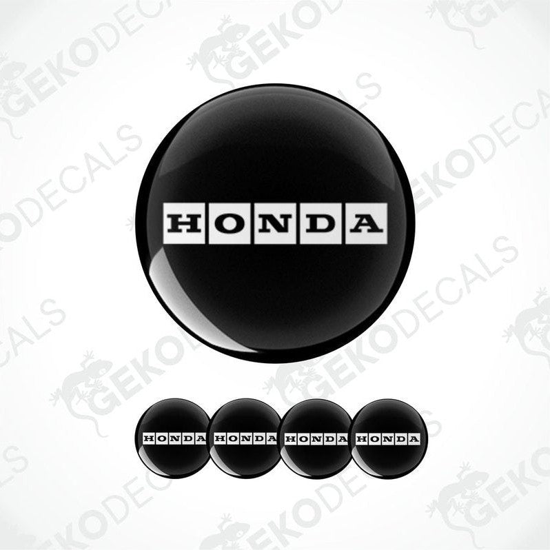 A set of black vinyl decals with the HONDA logo, including one large round decal and four smaller rectangular ones.