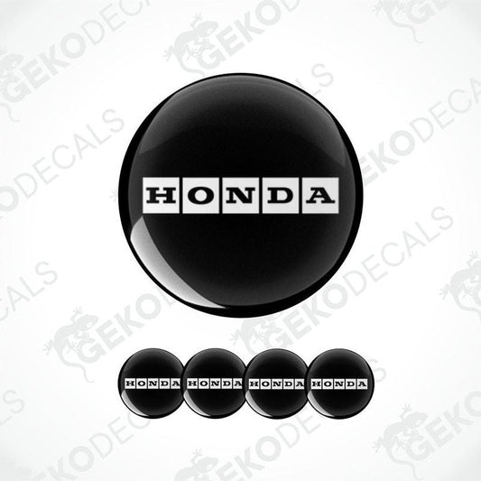 A set of black vinyl decals with the HONDA logo, including one large round decal and four smaller rectangular ones.
