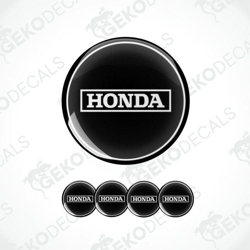 A set of four black and white vinyl stickers with the Honda brand logo.