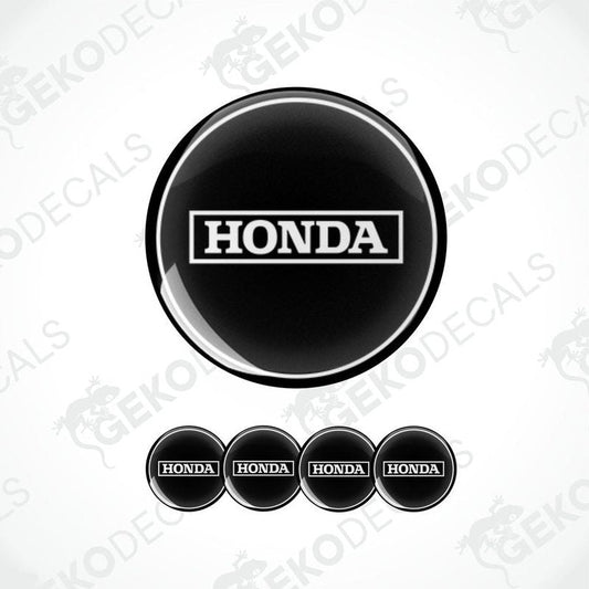 A set of four black and white vinyl stickers with the Honda brand logo.