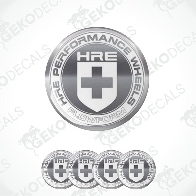 A set of silver-colored vinyl decals with the HRE Performance Wheels logo, which includes a shield shape with a cross and text.