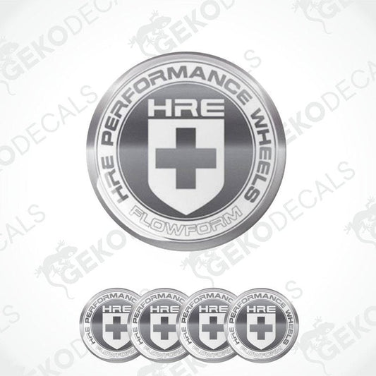 A set of silver-colored vinyl decals with the HRE Performance Wheels logo, which includes a shield shape with a cross and text.