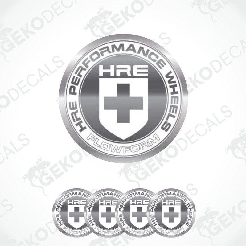 A set of silver-colored vinyl decals with the HRE Performance Wheels logo, which includes a shield shape with a cross and text.