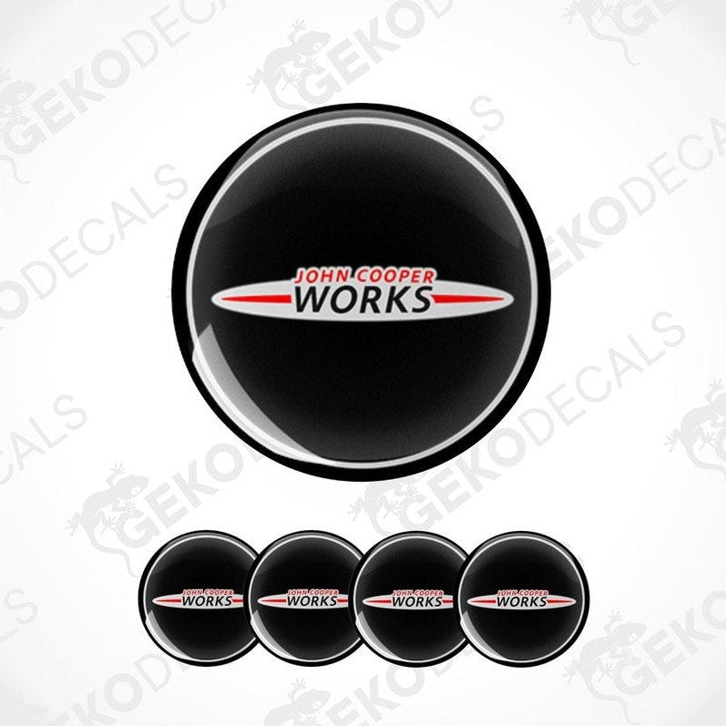 Set of four round car decals with 'John Cooper Works' branding, predominantly black with white and red text.