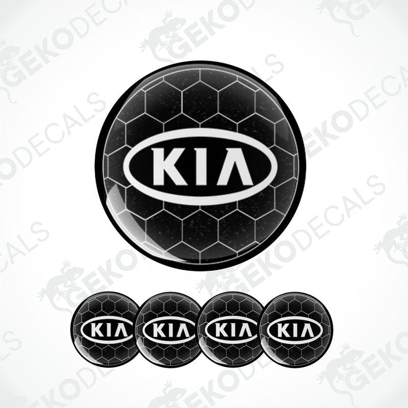 A set of four black vinyl stickers with the KIA brand logo designed to fit on car wheels.