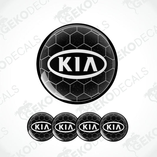 A set of four black vinyl stickers with the KIA brand logo designed to fit on car wheels.