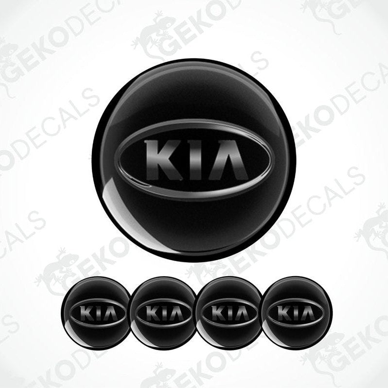 A set of four black vinyl stickers with the KIA brand logo on them.