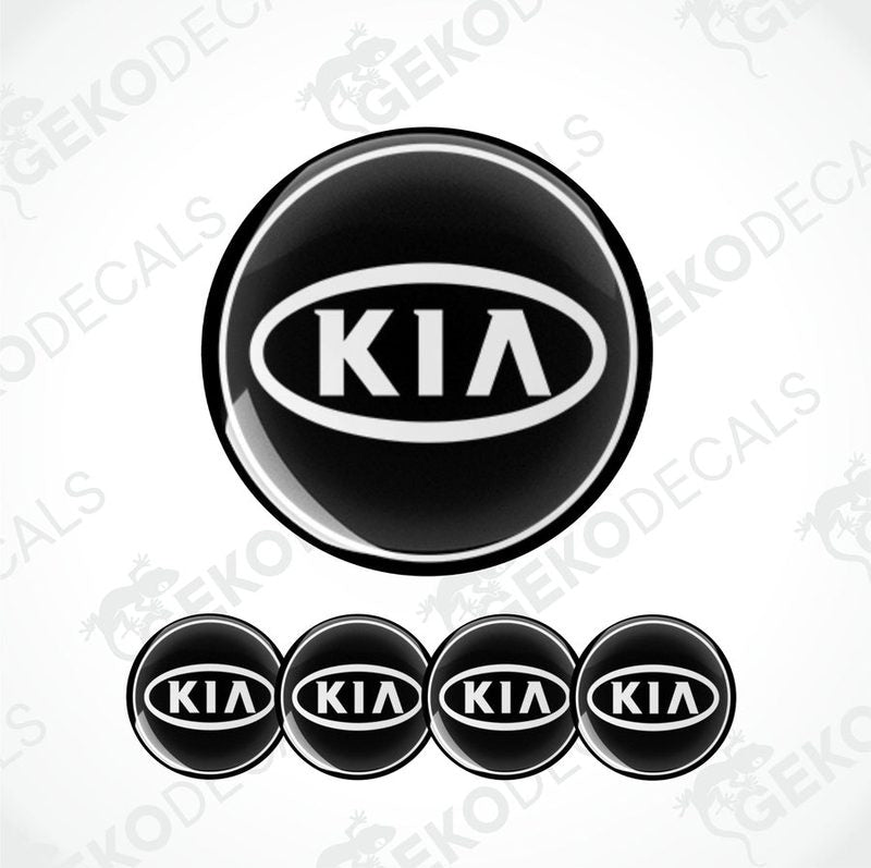 A set of four black vinyl stickers with the KIA brand logo on them.