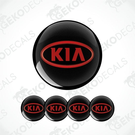 A set of four black vinyl stickers with the KIA brand logo in red.
