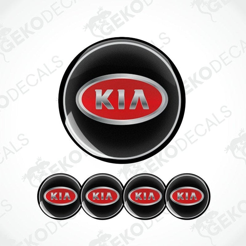 A set of four black vinyl stickers with the KIA brand logo in red and metallic grey.