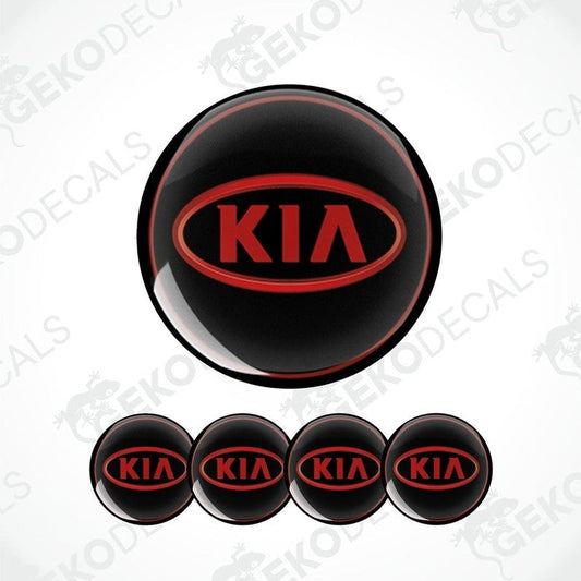 A set of four black vinyl stickers with the KIA brand logo in red.