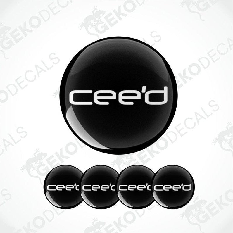A set of four black vinyl stickers with the word 'KIA CEED' and a geometric design.