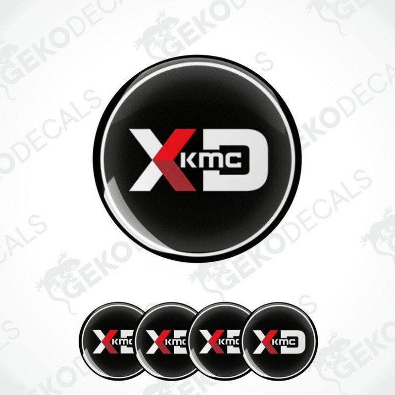 A set of four black, red, and white vinyl decals with the KMC logo, designed for use on car wheels.