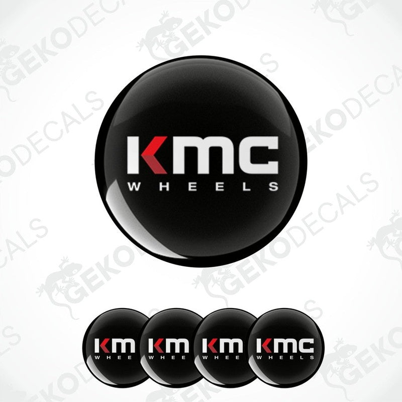 A set of four black vinyl stickers with the KMC Wheels logo printed on them.