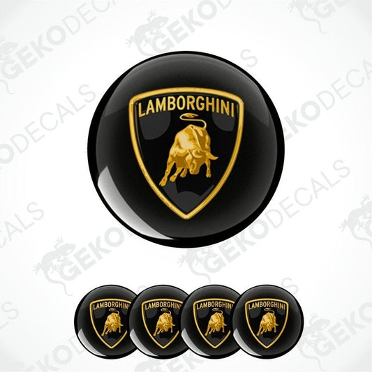 A set of four black vinyl stickers with the Lamborghini logo in gold, displayed on a white background.