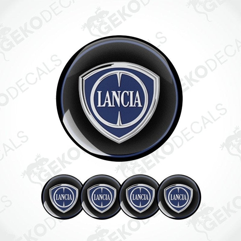 A set of four black vinyl stickers with the LANCIA brand logo in white and blue.