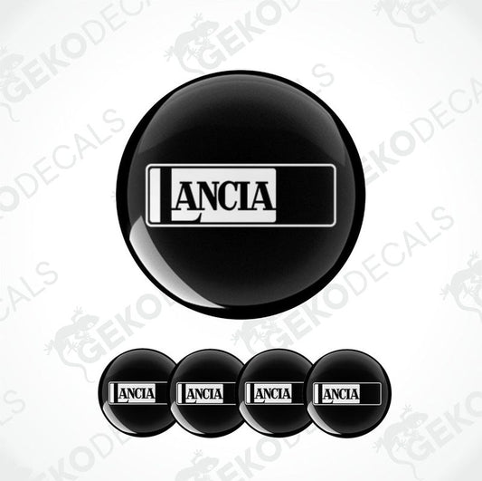 A set of four black vinyl stickers with the word 'LANCIA' printed on them, designed to be used as car decals.