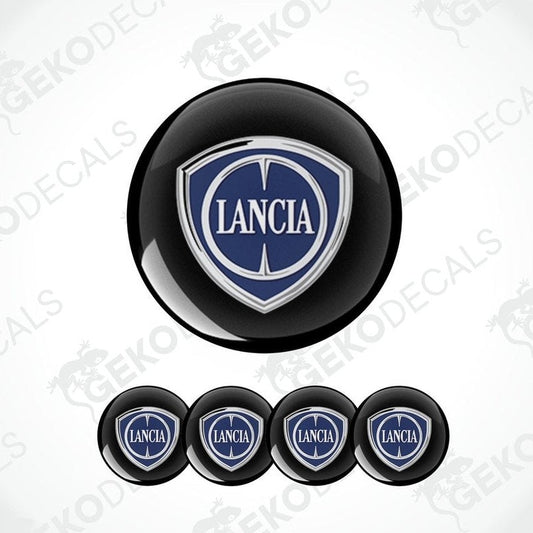 A set of four black vinyl stickers with the LANCIA brand logo in white and blue.