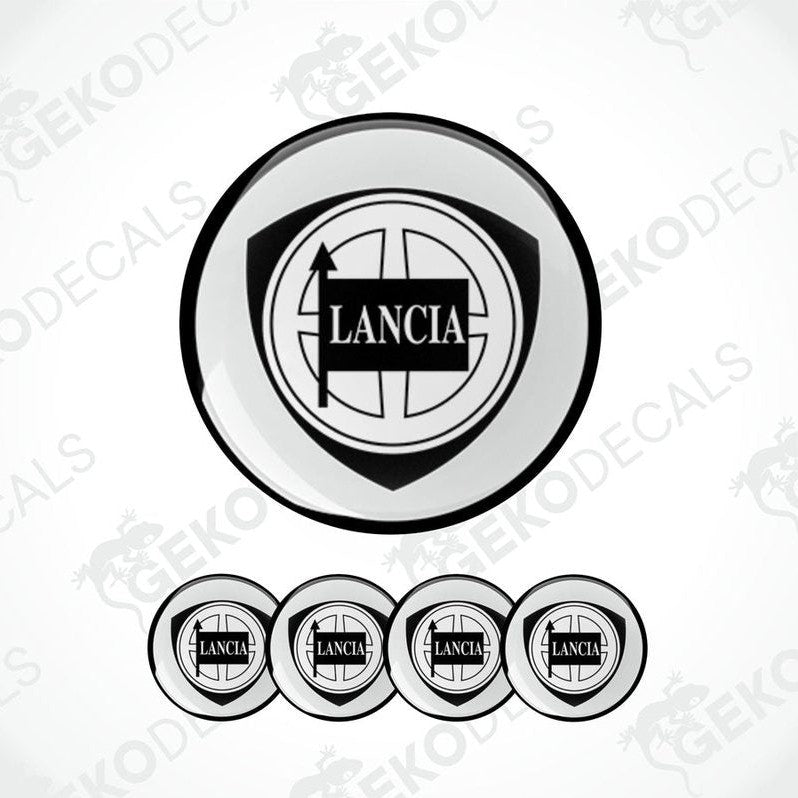 A set of four white vinyl stickers with the LANCIA brand logo and a geometric design, displayed on a white background.