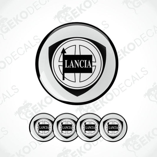 A set of four white vinyl stickers with the LANCIA brand logo and a geometric design, displayed on a white background.