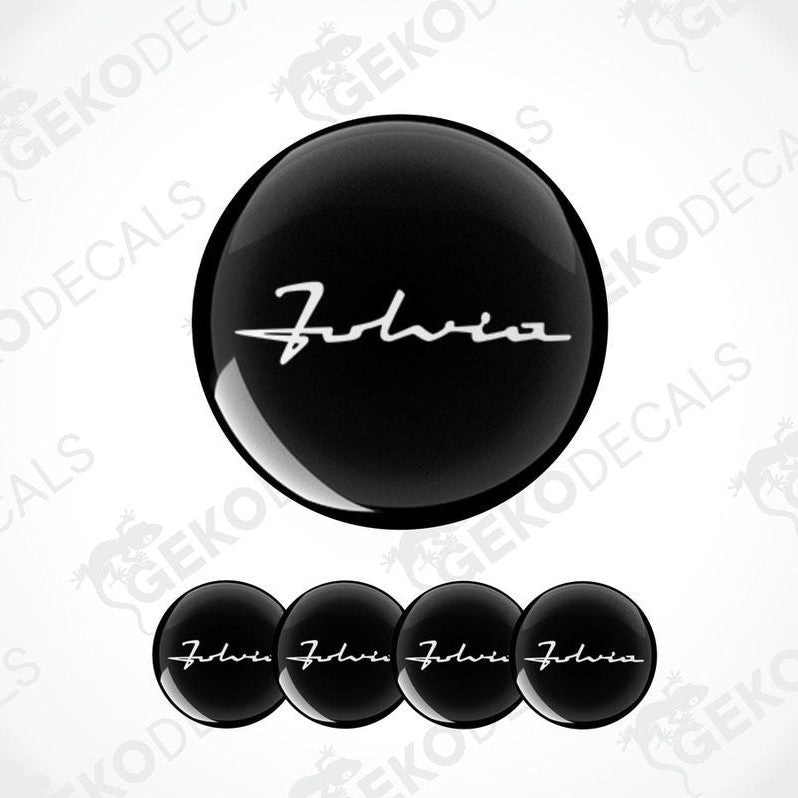 Set of four black vinyl decals with the text 'LANCIA FABIA' on them, presented against a white background.