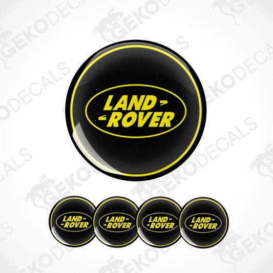 A set of four black vinyl stickers with the text 'LAND ROVER' in yellow. Each sticker has a different size, designed to fit on a car wheel.