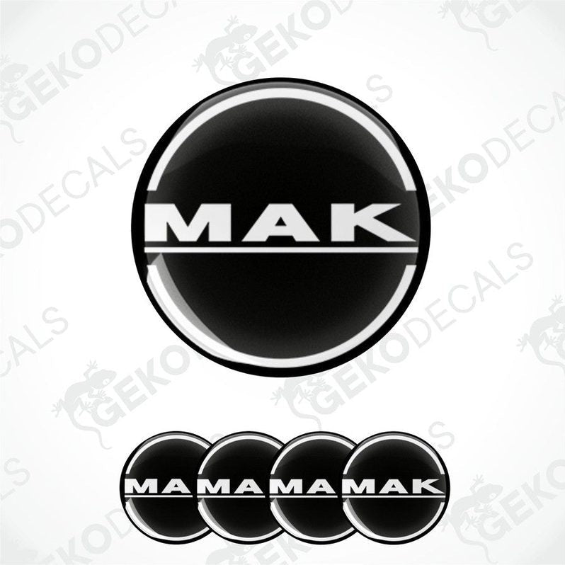 A set of black and white vinyl decals with the text 'MAK' and 'MAMAMAK' arranged in a pattern, indicative of wheel caps or car decals.
